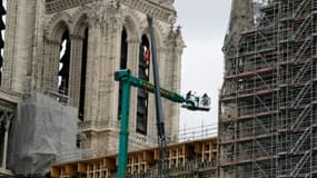 Des ouvriers travaillent sur l'échafaudage de la cathédrale Notre-Dame de Paris, le 11 mars 2020