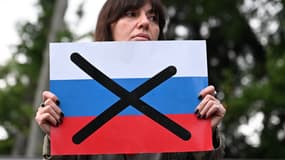 Une femme tenant un drapeau russe barré en Géorgie, le 3 mai 2024