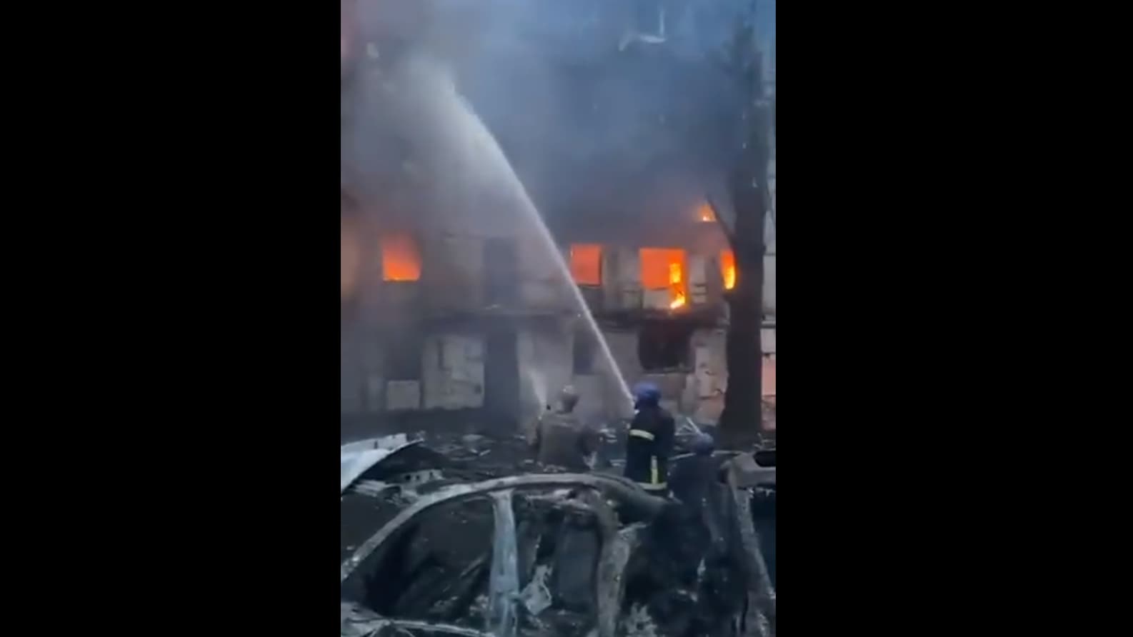 Cette capture d'écran d'une vidéo montrant une personne tentant d'éteindre l'incendie dans un bâtiment de Kryvyi Rih après la frappe de missile qui a fait trois morts et 25 blessés dans un immeuble d'habitation.