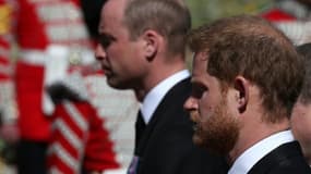 Le prince William, duc de Cambridge (g) et le prince Harry, duc de Sussex, suivent le cercueil de leur défunt grand-père, le prince Philip, duc d'Edimbourg, vers la chapelle Saint-George du château de Windsor, à l'ouest de Londres, le 17 avril 2021