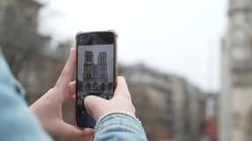 Un touriste prenant une photo de la cathédrale Notre-Dame-de-Paris.