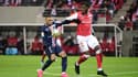 Axel Disasi (Reims) au duel avec Kylian Mbappé