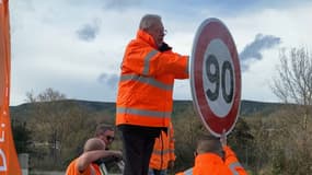 Jean-Louis Masson, président du conseil départemental du Var, installe un panneau de limite de vitesse à 90km/h.