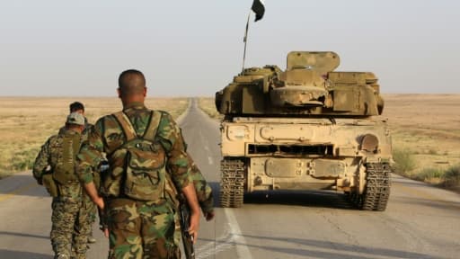 Des soldats syriens sécurisent une route dans la zone désertique d'As Sab'Biyar, près de la frontière avec l'Irak, le 10 mai 2017