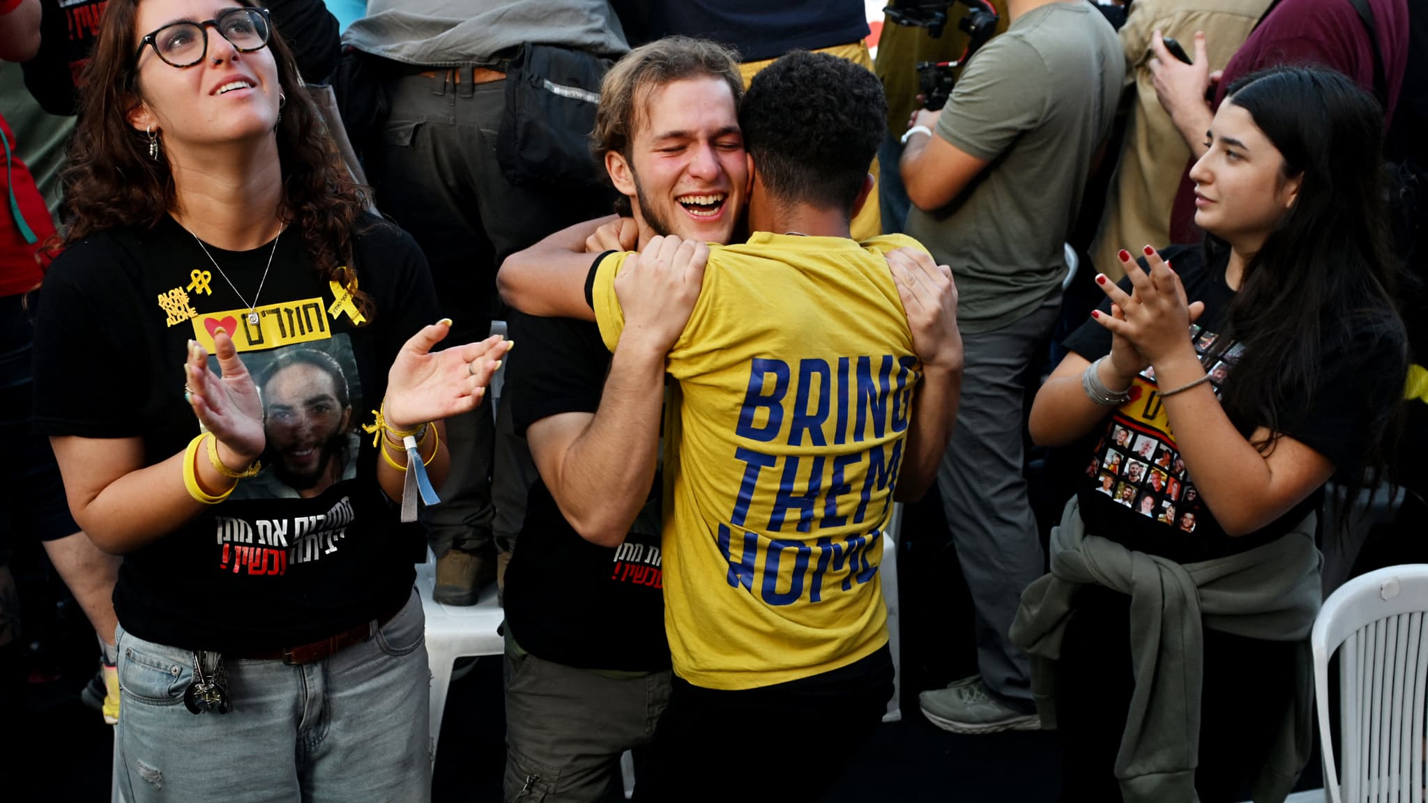 People react as they watch the live broadcast of the hostage release in Hostage Square on October 13, 2025 in Tel Aviv, Israel.