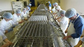 Des employés de la conserverie la "Belle-Iloise", étripant et étêtant des sardines avant leurs mises en boites, le 24 Juin 2003 à Quiberon. (Illustration)