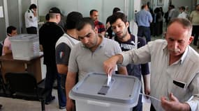 Dans un bureau de vote de Damas. Les Syriens votaient lundi pour des élections législatives présentées par le pouvoir comme une vitrine des réformes politiques en cours et par l'opposition comme une farce sur fond de répression sanglante des manifestants
