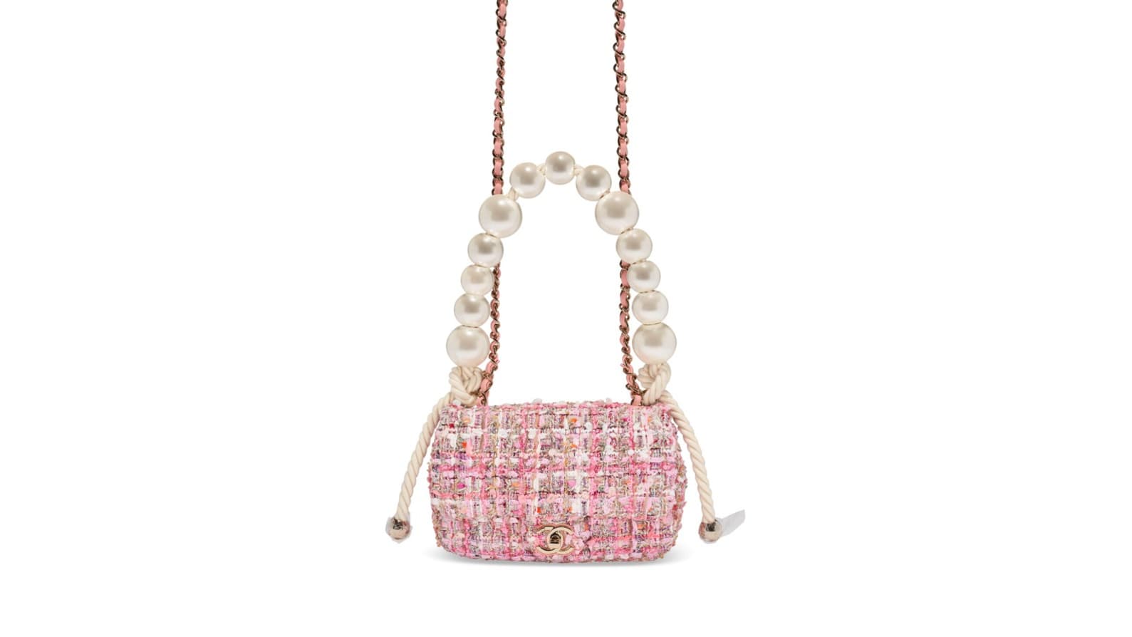 Un mini-sac à rabat Chanel en tweed rose et à la poignée perlée vendu chez Christie's Un mini-sac à rabat Chanel en tweed rose et à la poignée perlée vendu chez Christie's