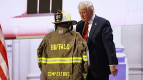 Donald Trump observe une minute de silence en hommage à Corey Comperatore, le spectateur tué lors de sa tentative d'assassinat, aux côtés de sa tenue de pompier volontaire, lors d'un meeting, à Milwaukee, le 18 juillet 2024