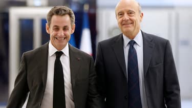 Nicolas Sarkozy et Alain Juppé, fin 2014 au siège de l'UMP à Paris, quelques jours après l'élection à la présidence du premier cité