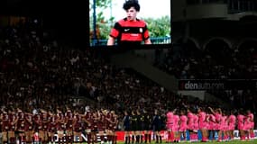 Les joueurs observent une minute de silence en hommage à Medhi Narjissi (écran) disparu en mer lors d'un stage avec l'équipe de France junior de rugby au stade Chaban-Delmas à Bordeaux, le 7 septembre 2024