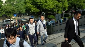 Un couple homosexuel, Hu Mingliang (centre d) et son conjoint Sun Wenlin (centre g) à l'arrivée au tribunal de Changsha, en Chine, le 13 avril 2016