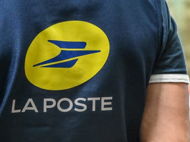 Un employé de La Poste porte un T-shirt arborant le logo de l'entreprise dans un bureau de poste de Lille, le 2 juin 2023 (photo d'illustration).