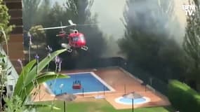 Espagne: un hélicoptère collecte de l'eau dans une piscine avant de la verser sur un incendie