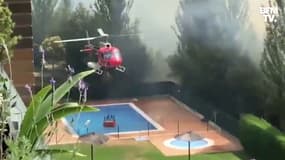 Espagne: un hélicoptère collecte de l'eau dans une piscine avant de la verser sur un incendie