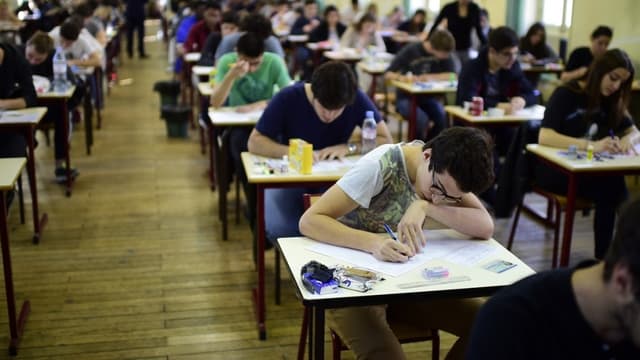 Des bacheliers travaillent sur leurs épreuves.