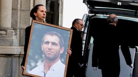 Une femme tient le portrait de Federico Martin Aramburu durant les funérailles du joueur de rugby argentin à Biarritz, le 26 mars 2022